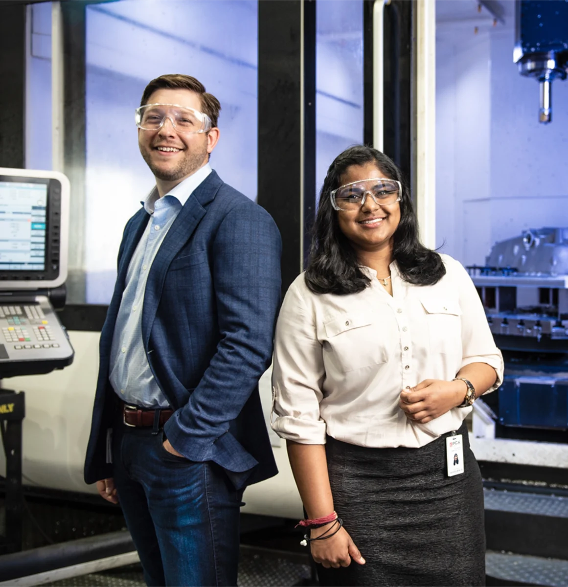 Male and Female Business Analytics & Project Management students standing posing for photo.
