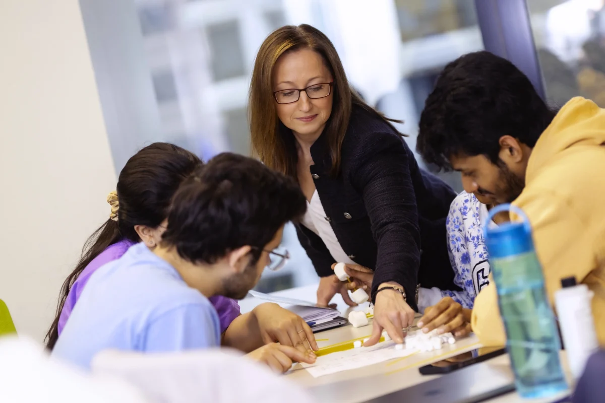 MS in BAPM instructor interacting with students.