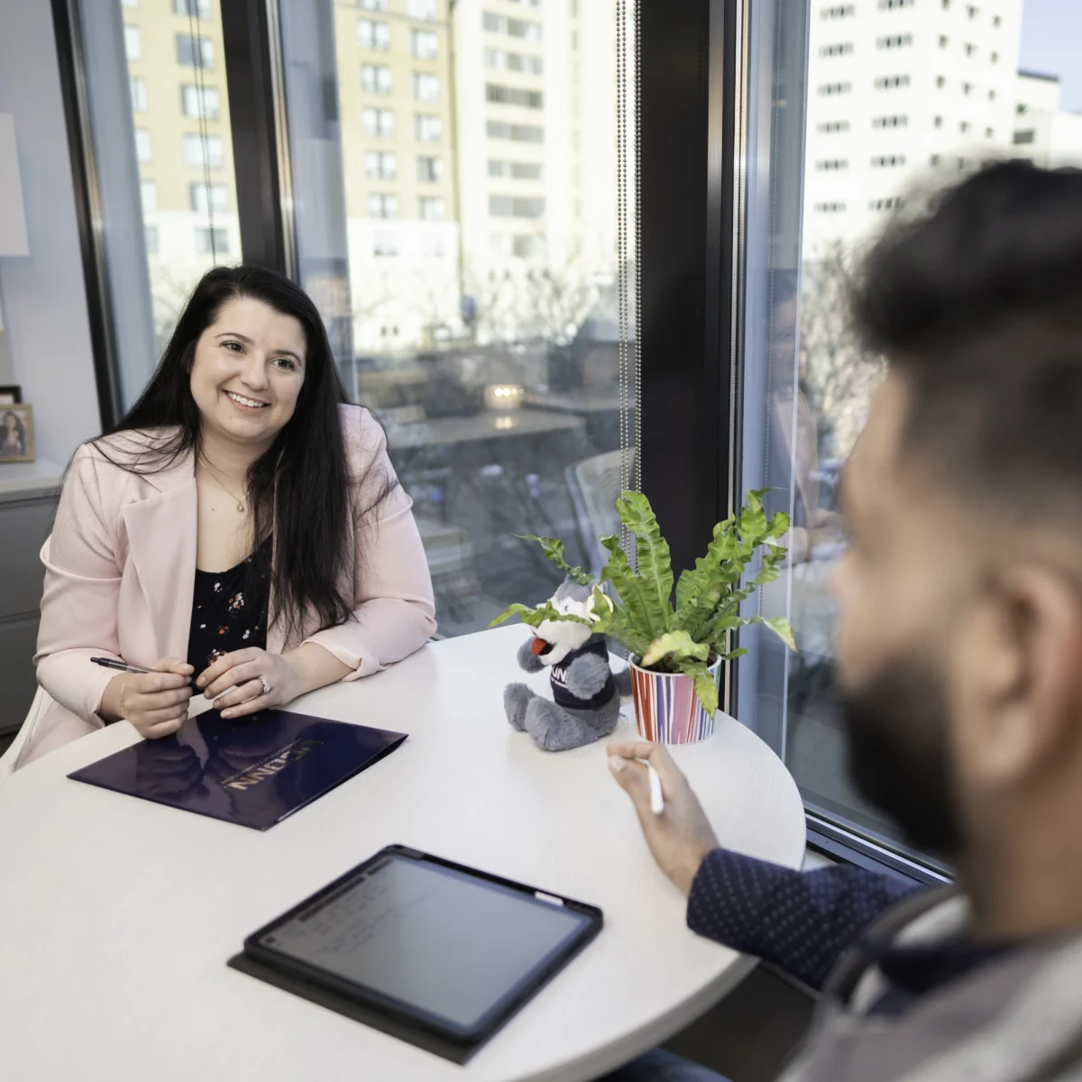 UConn Business Analytics and Project Management intern talking with colleague.